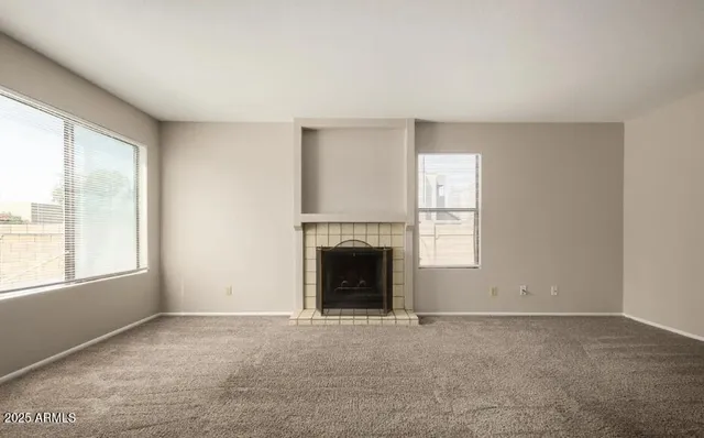 a view of empty room with a fireplace