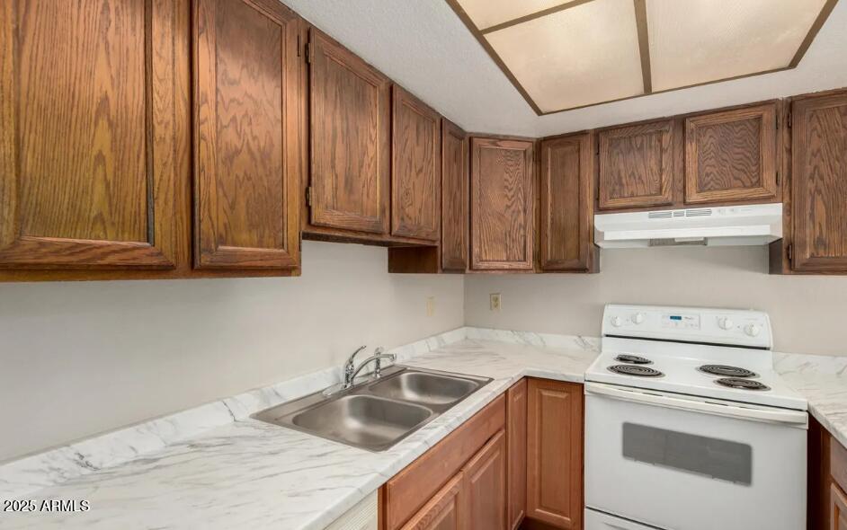 2040 South Longmore, Unit 66 Mesa, AZ 85202 - Photo 9 of 25 a kitchen with stainless steel appliances granite countertop a sink a stove and cabinets
