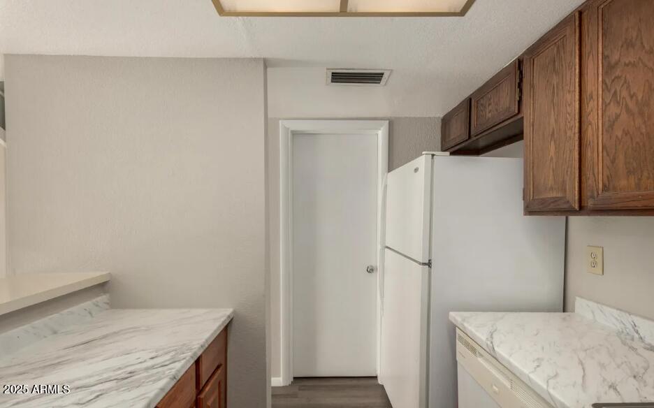 2040 South Longmore, Unit 66 Mesa, AZ 85202 - Photo 10 of 25 a kitchen with a refrigerator and a stove top oven