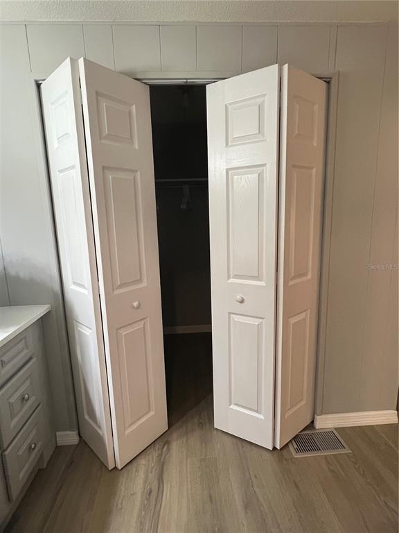 1100 South Belcher Road, Unit 469 Largo, FL 33771 - Photo 40 of 69 an empty room with wooden floor and closet