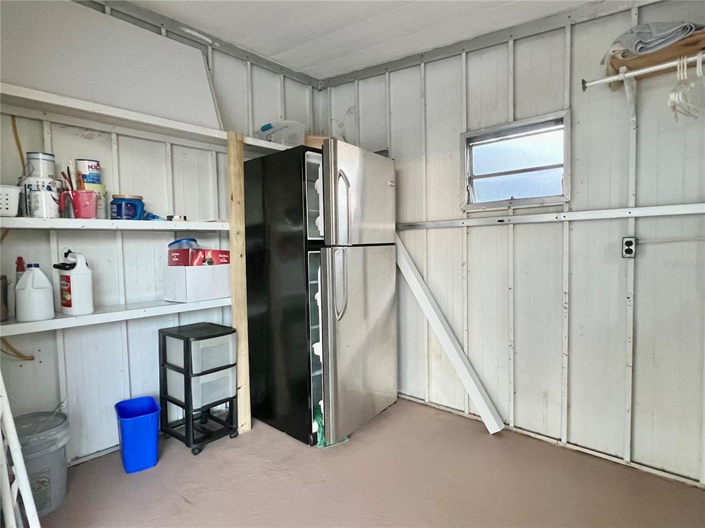 1100 South Belcher Road, Unit 469 Largo, FL 33771 - Photo 50 of 69 a kitchen with refrigerator and cabinets