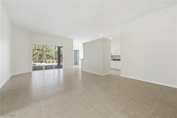 a view of a livingroom with an empty space and a window