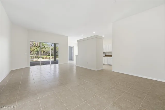 a view of a livingroom with an empty space and a window