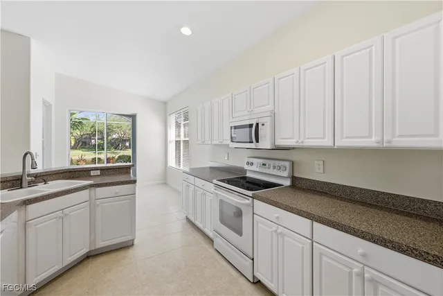 a kitchen with granite countertop white cabinets and a granite counter tops