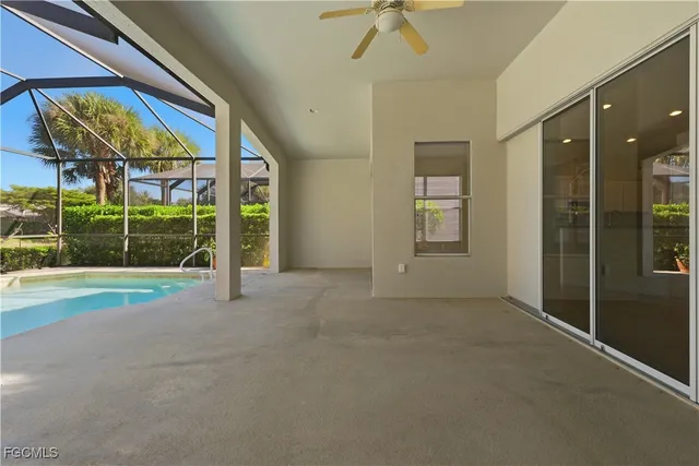 a view of a patio with a table and chairs under an umbrella