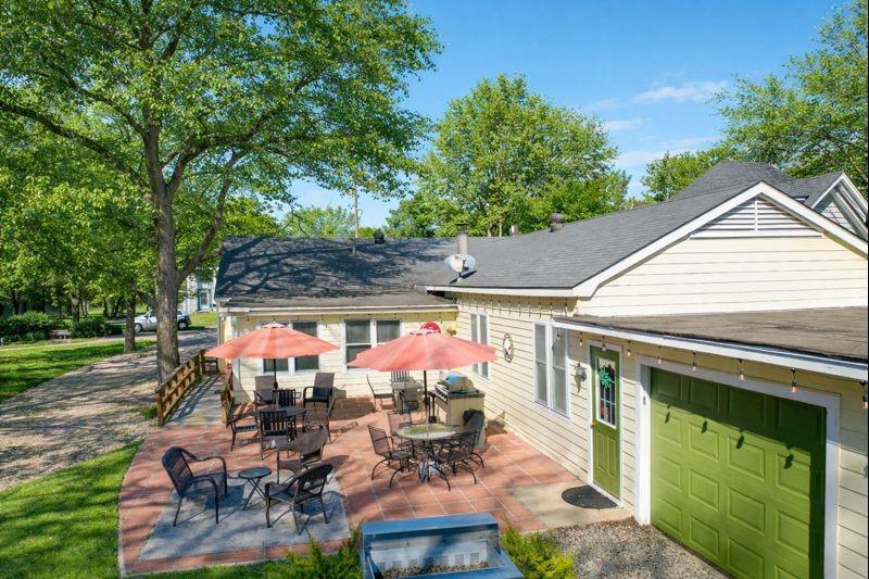 1505 Bonham Street Commerce, TX 75428 - Photo 37 of 39 Large lot with attached garage, carport, and outdoor cooking area. Grass and trees digitally enhanced to show seasonal potential