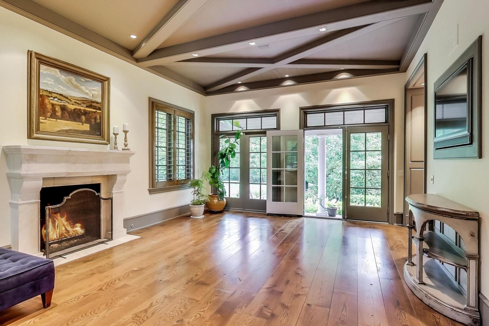 701 Plamondon Road Wheaton, IL 60189 - Photo 22 of 79 a view of an empty room with wooden floor and a fireplace