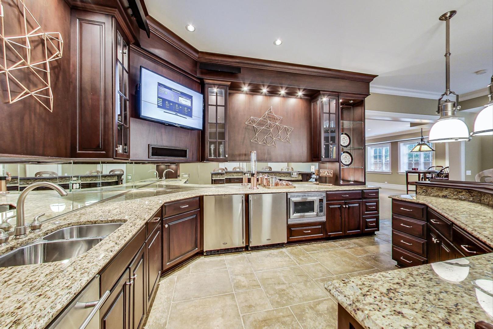 701 Plamondon Road Wheaton, IL 60189 - Photo 28 of 79 a kitchen with stainless steel appliances granite countertop a sink and stove top oven