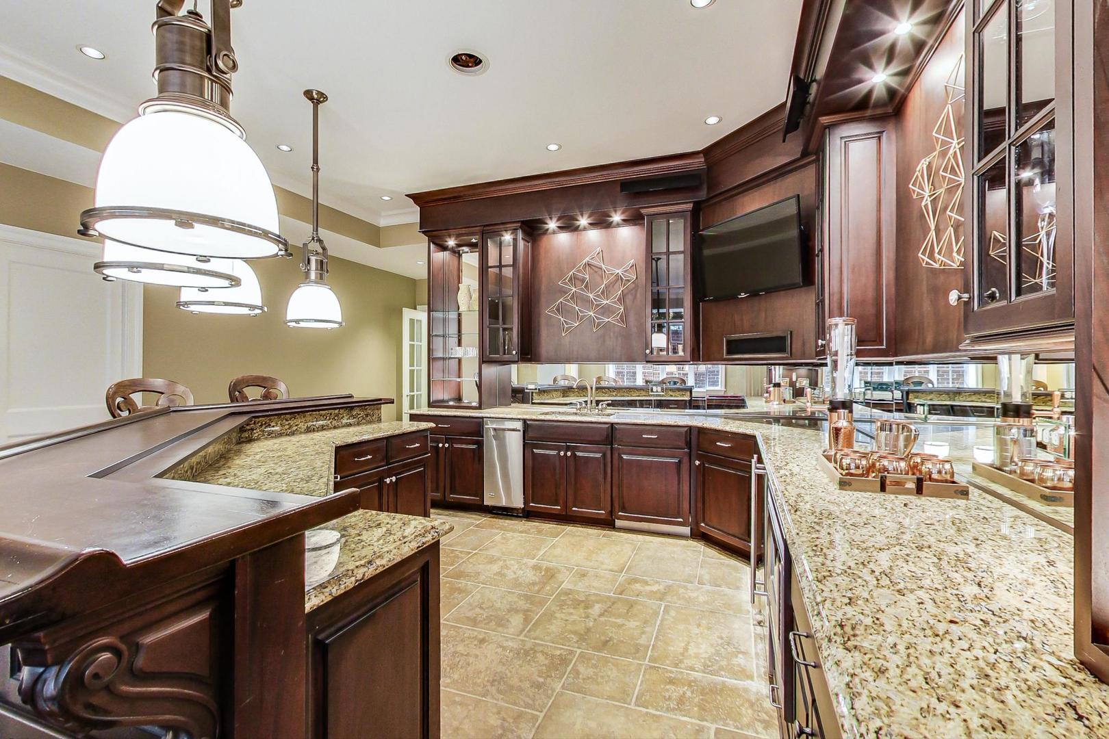 701 Plamondon Road Wheaton, IL 60189 - Photo 29 of 79 a kitchen with stainless steel appliances granite countertop a sink a stove and a wooden floors