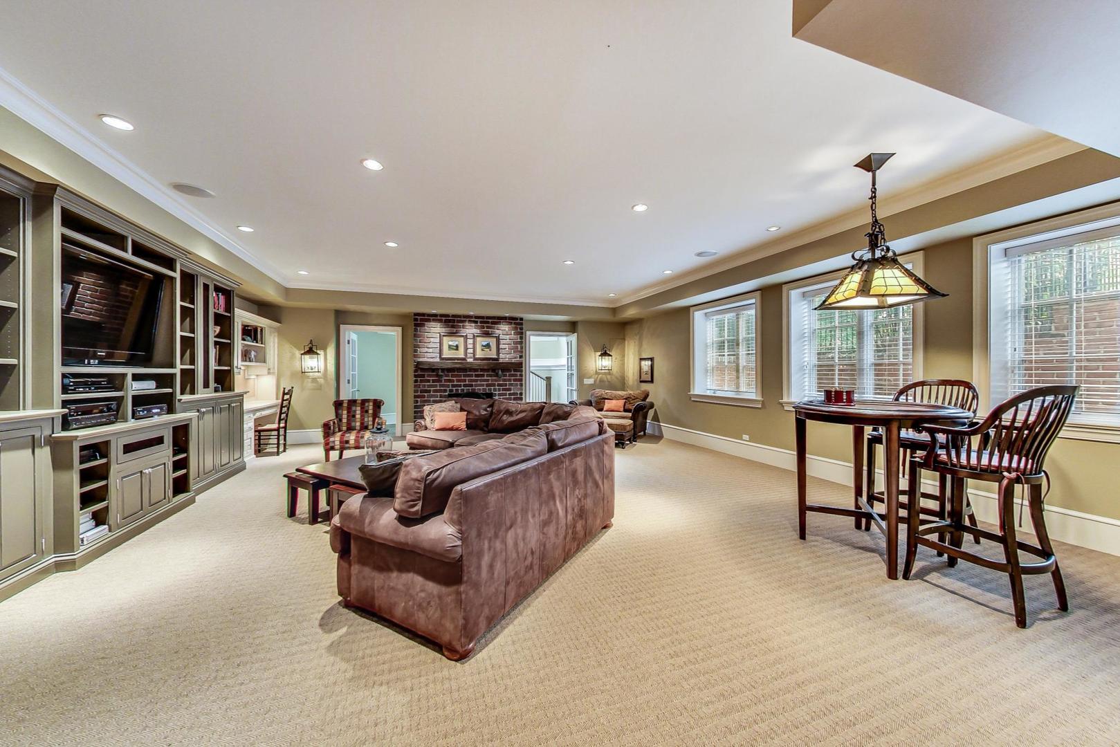 701 Plamondon Road Wheaton, IL 60189 - Photo 33 of 79 a living room with furniture a flat screen tv and a chandelier