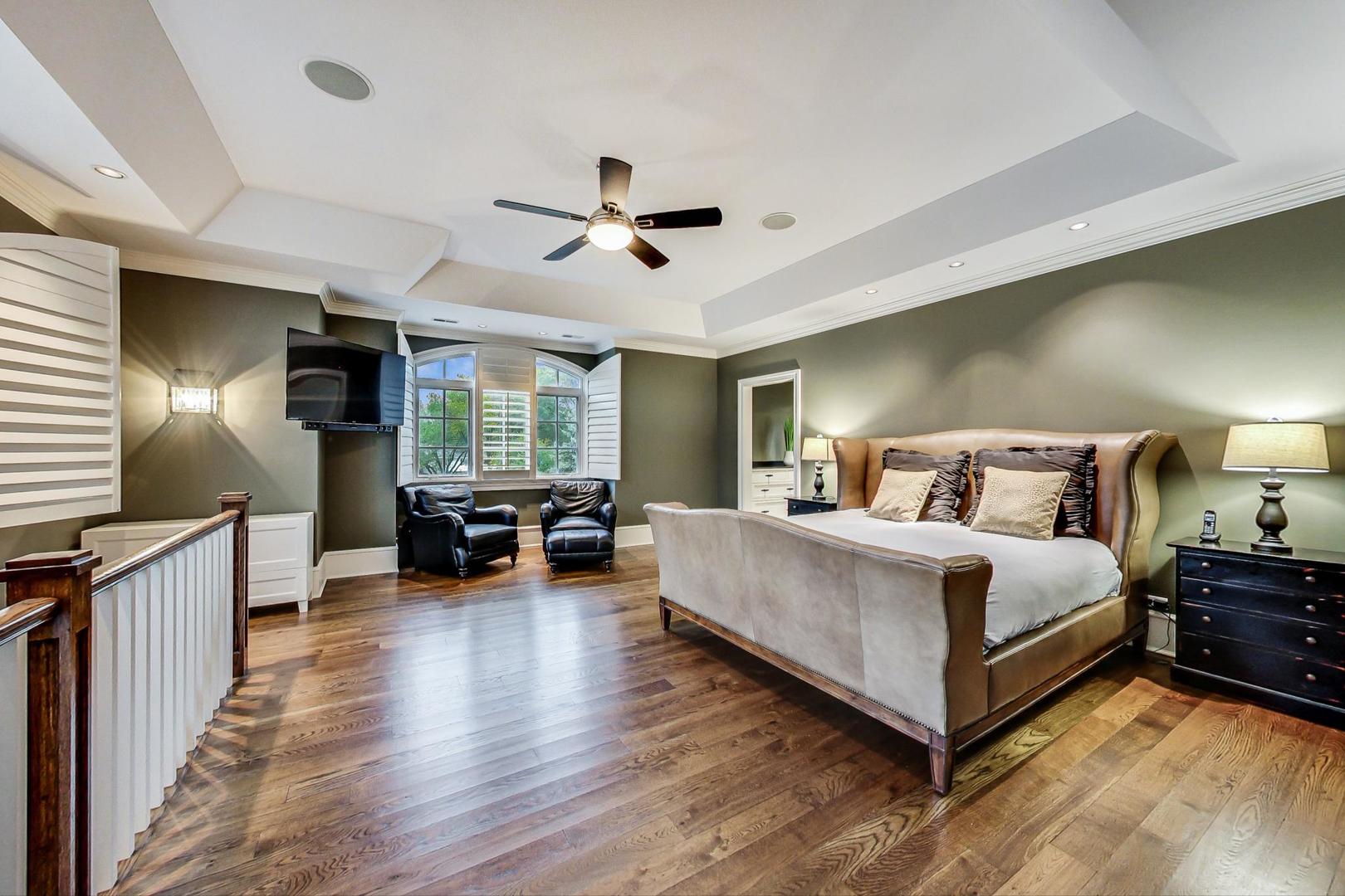 701 Plamondon Road Wheaton, IL 60189 - Photo 47 of 79 a spacious bedroom with a bed a dresser and a chandelier