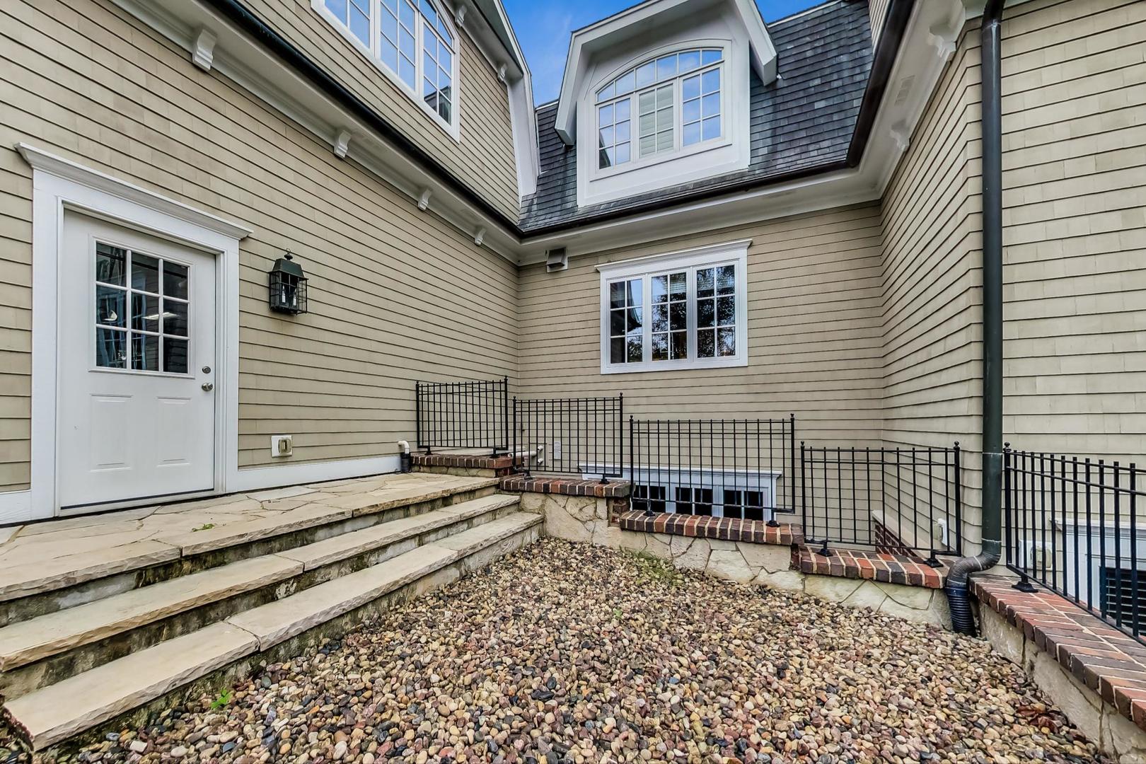 701 Plamondon Road Wheaton, IL 60189 - Photo 62 of 79 a view of a brick house with many windows