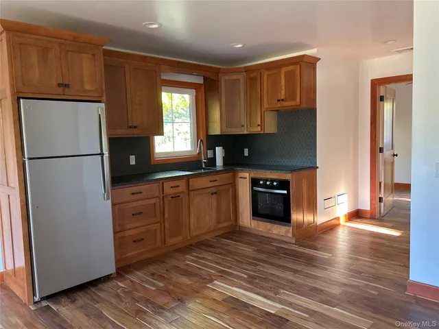 a kitchen with stainless steel appliances granite countertop a refrigerator sink and cabinets