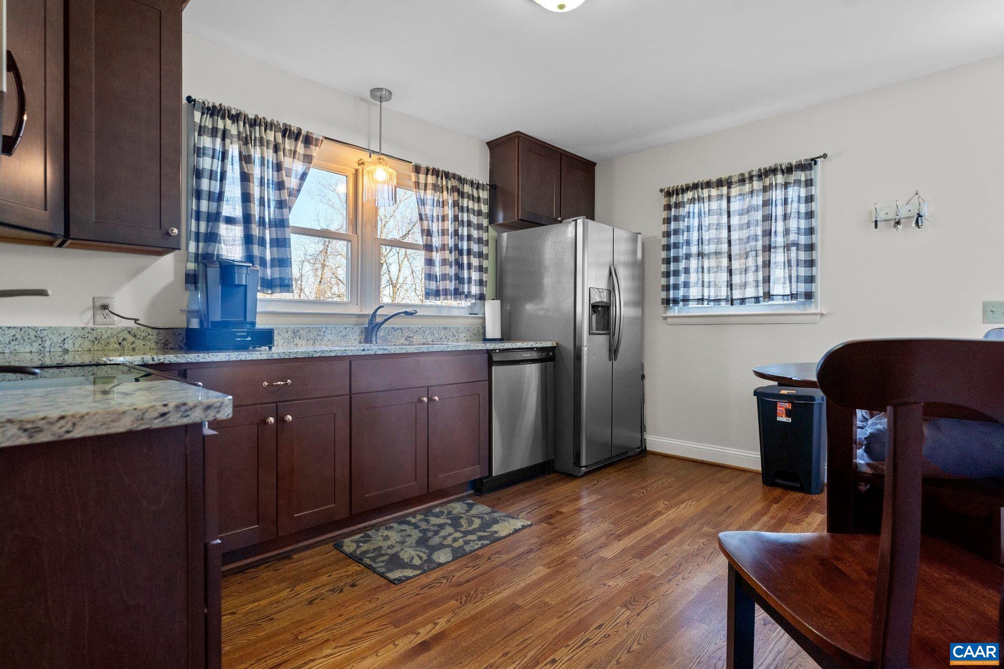284 Jericho Road Fishersville, VA 22939 - Photo 21 of 30 a kitchen with stainless steel appliances granite countertop a refrigerator a sink dishwasher and wooden cabinets with wooden floor