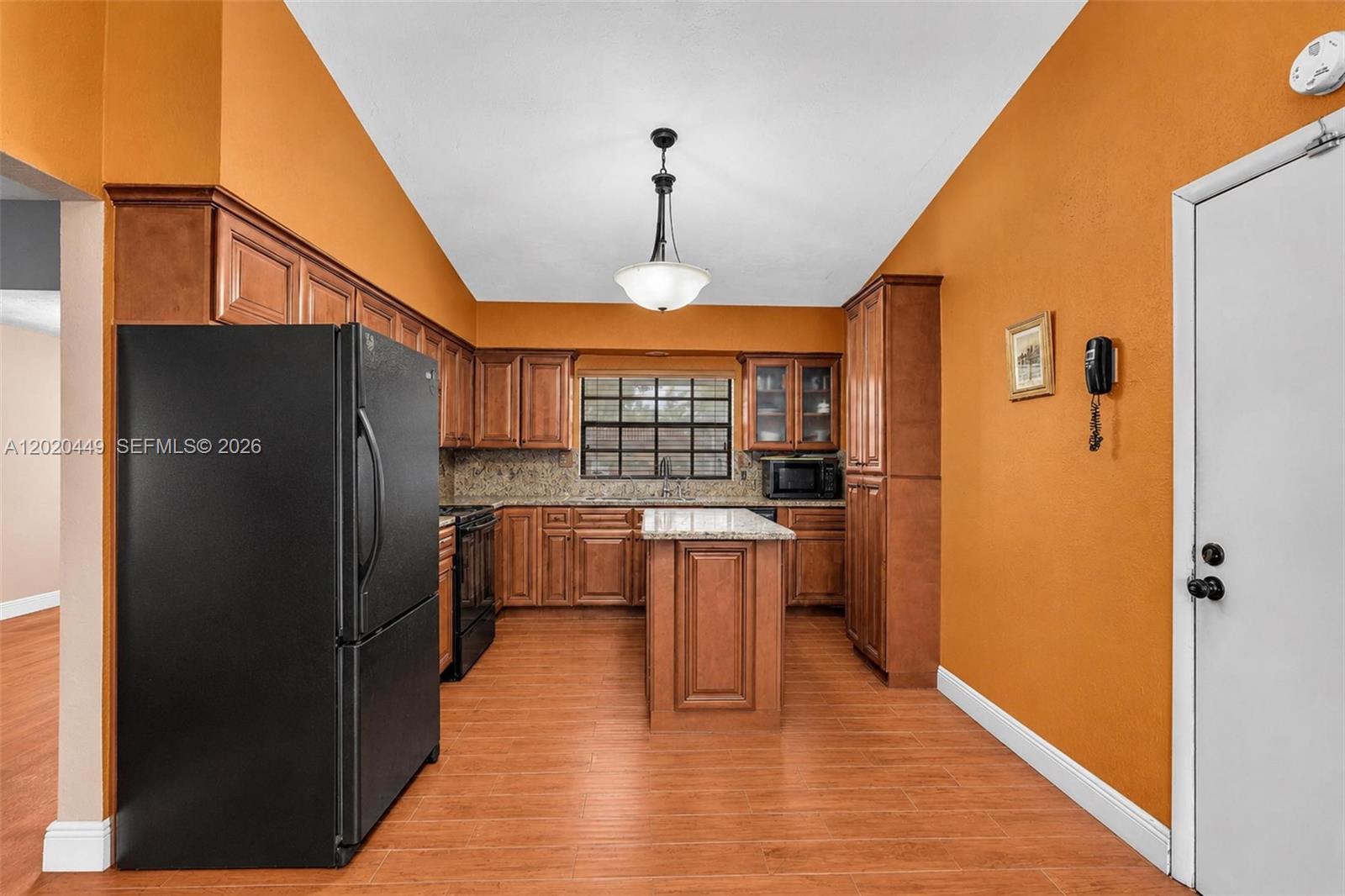 11061 Southwest 163rd Street Miami, FL 33157 - Photo 6 of 42 a kitchen with stainless steel appliances a refrigerator and wooden floor