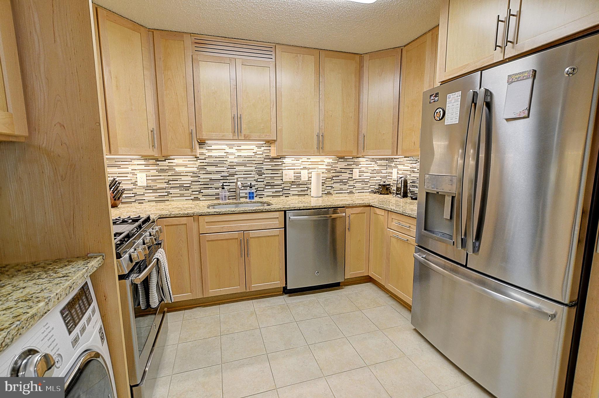 5225 Pooks Hill Road, Unit 121N Bethesda, MD 20814 - Photo 15 of 39 a kitchen with stainless steel appliances a refrigerator sink and cabinets