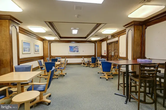 a room with gym equipment and wooden floor