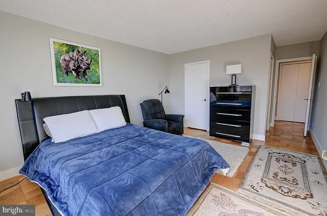 a bedroom with a bed and a dresser