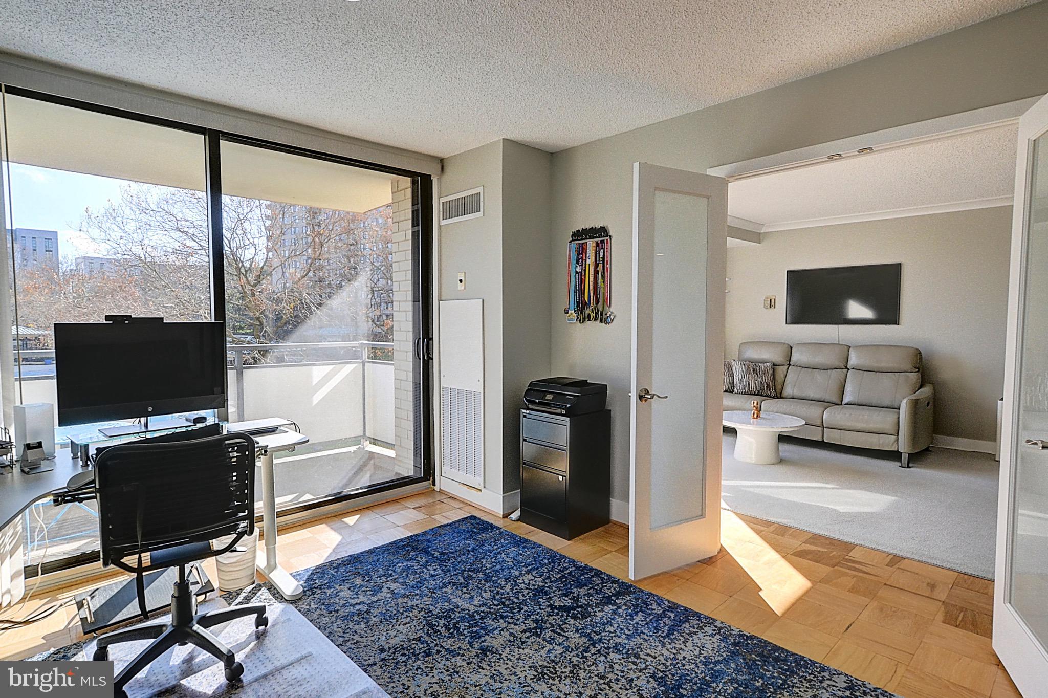 5225 Pooks Hill Road, Unit 121N Bethesda, MD 20814 - Photo 10 of 39 a living room with furniture and a flat screen tv