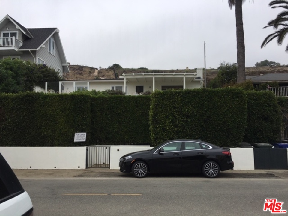 25121 Malibu Road Malibu, CA 90265 - Photo 15 of 16 a car parked in front of a house