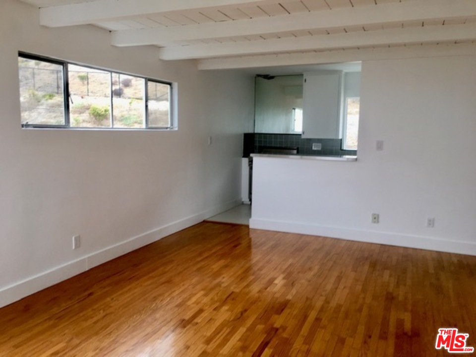 25121 Malibu Road Malibu, CA 90265 - Photo 7 of 16 a view of empty room with wooden floor and fan