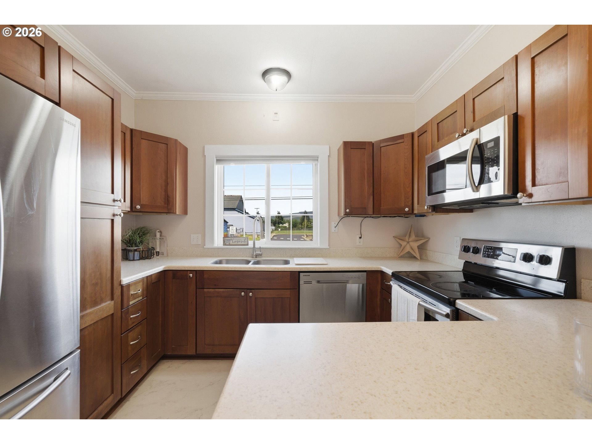 1802 8th Street Tillamook, OR 97141 - Photo 16 of 37 a kitchen with stainless steel appliances granite countertop a refrigerator a sink a stove a microwave and wooden cabinets
