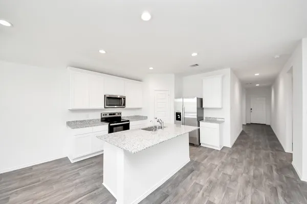a kitchen with stainless steel appliances granite countertop a stove and a sink