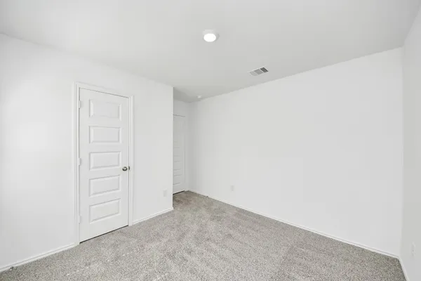 an empty room with closet area