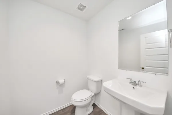 a white toilet sitting next to a bathroom sink