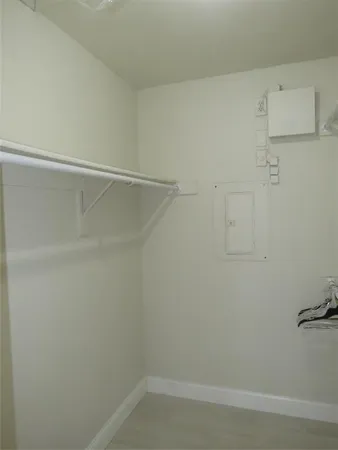 an empty room with an entryway and sink