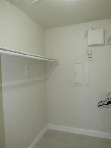 an empty room with an entryway and sink