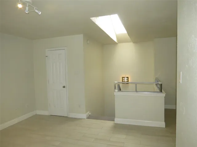 a view of a livingroom with workspace and a window