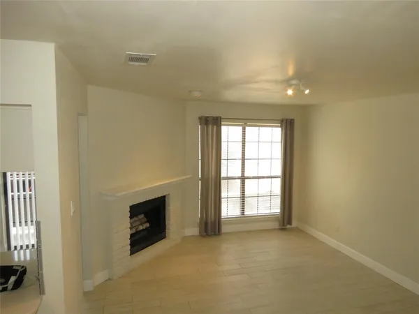 a view of a livingroom with workspace and a window