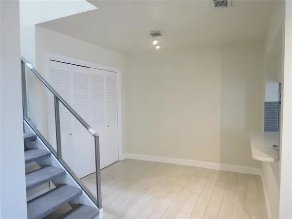 a view of an empty room with stairs