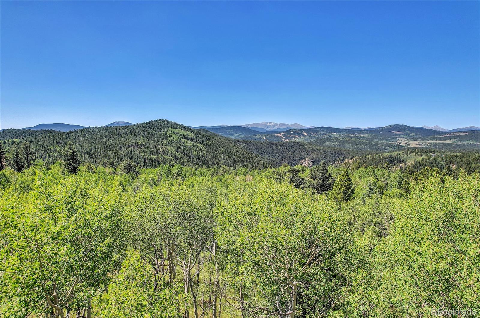 5 Hughesville Road Black Hawk, CO 80422 - Photo 12 of 17 a view of a mountain range with lush green forest