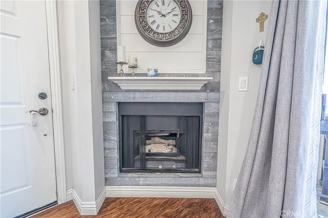 a living room with a fireplace and a rug