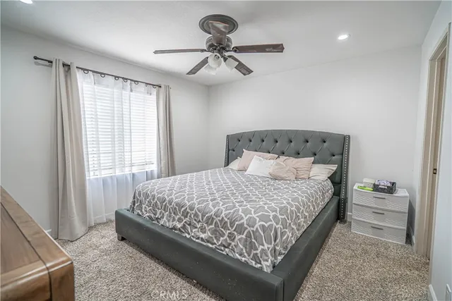 a bedroom with a bed and window