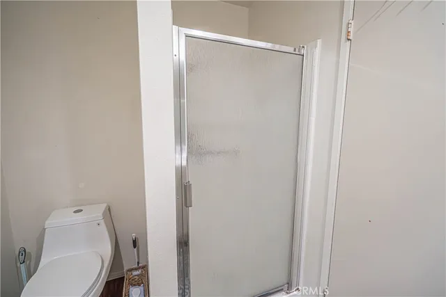 a bathroom with a toilet and shower