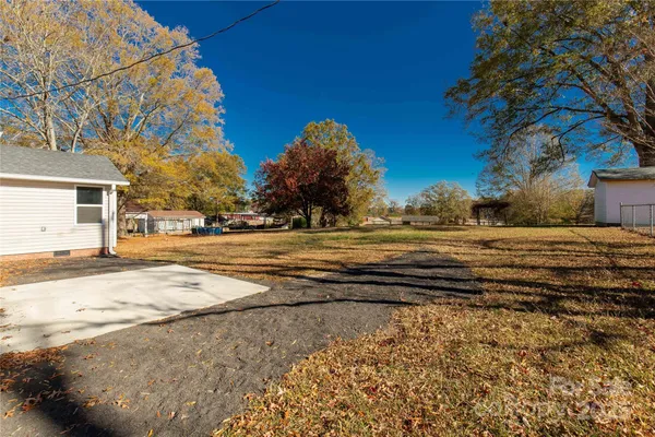 a front view of house with yard and trees