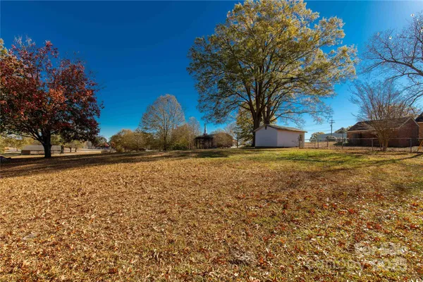 an empty room with window and wooden floor