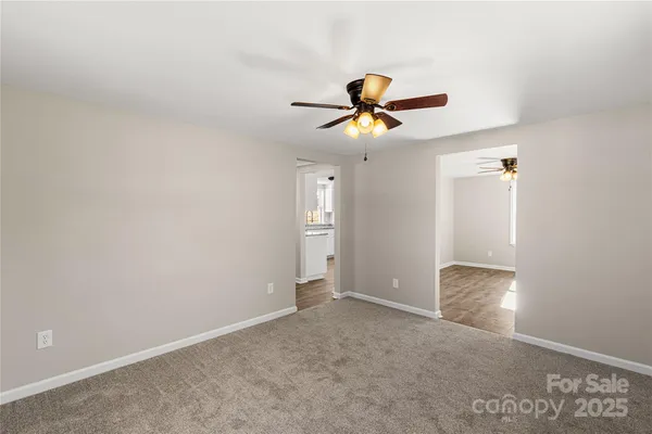 a view of room with window and ceiling fan