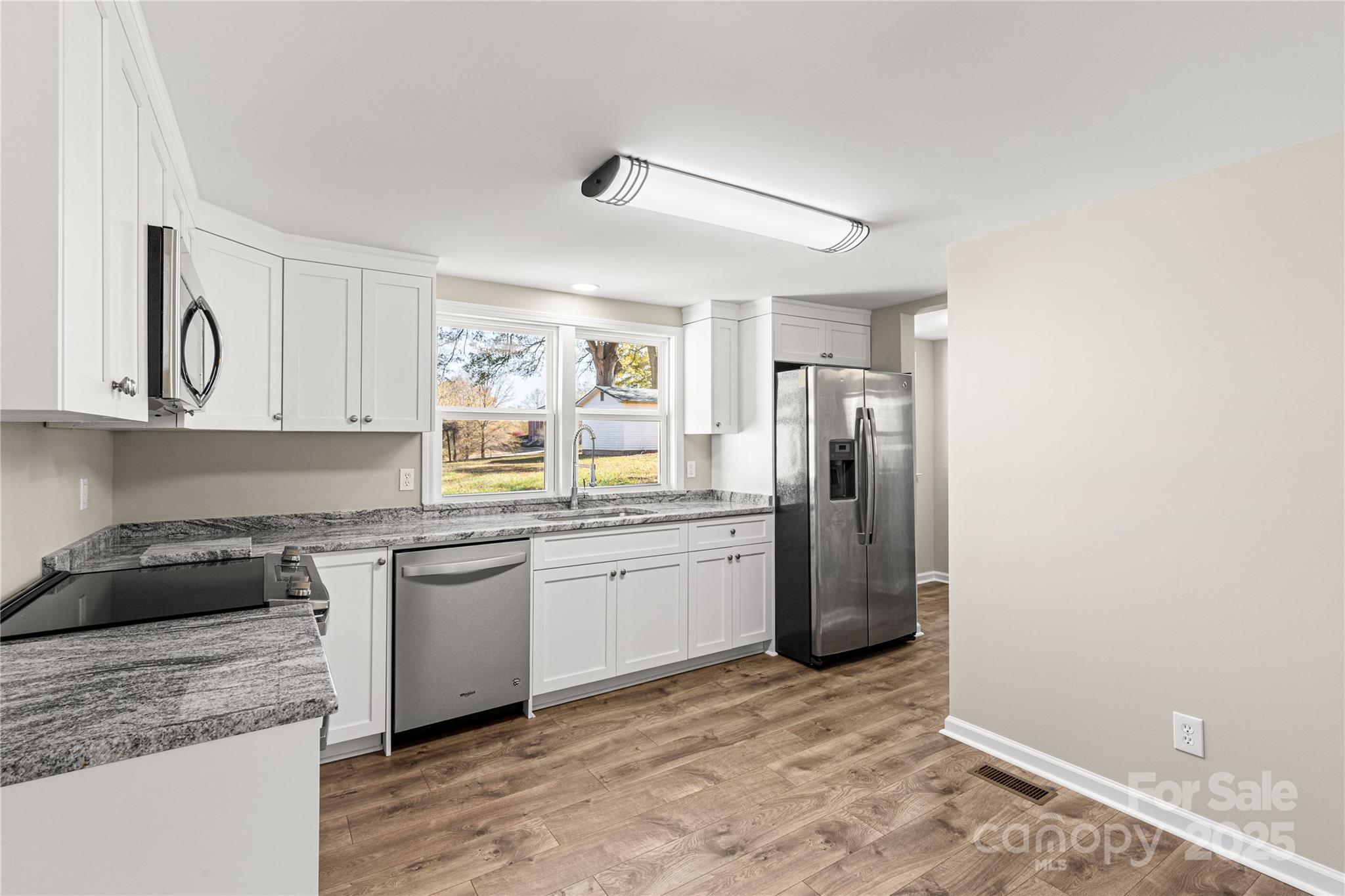 2429 State Rd S-29-746 Lancaster, SC 29720 - Photo 21 of 31 a kitchen with stainless steel appliances granite countertop a sink stove and refrigerator