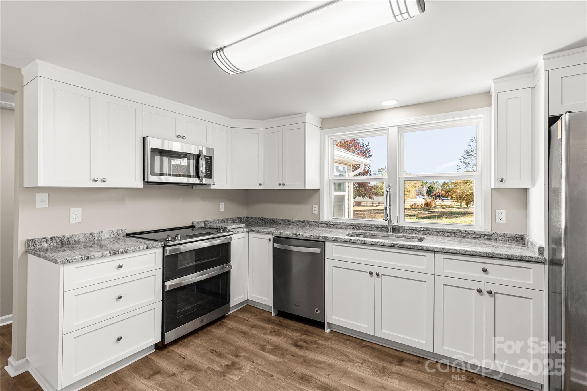 2429 State Rd S-29-746 Lancaster, SC 29720 - Photo 22 of 31 a kitchen with granite countertop white cabinets and white appliances