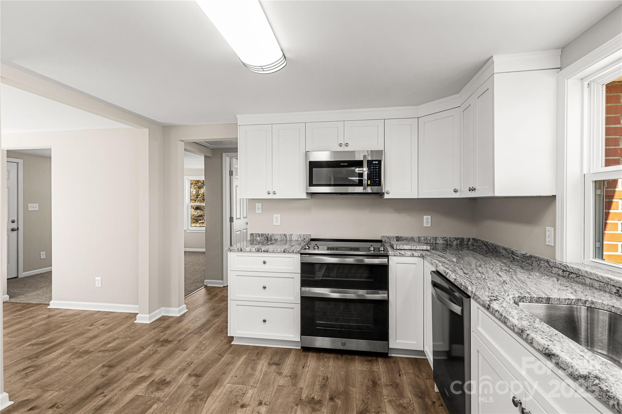 2429 State Rd S-29-746 Lancaster, SC 29720 - Photo 23 of 31 a kitchen with stainless steel appliances granite countertop a stove and a sink
