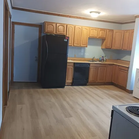 a kitchen with a refrigerator and a sink