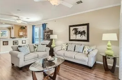 a living room with furniture and a lamp