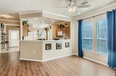 a view of a kitchen with stainless steel appliances granite countertop a stove top oven