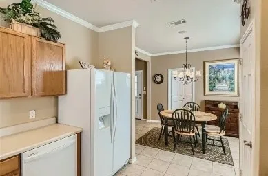 a kitchen with stainless steel appliances a refrigerator a table and chairs