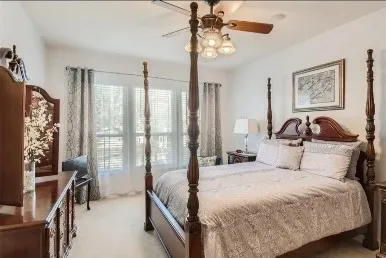 a bedroom with a large bed and a chandelier