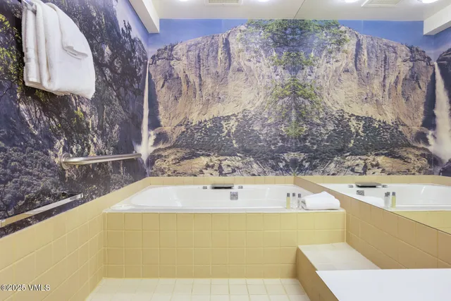 a bathroom with a bathtub and shower